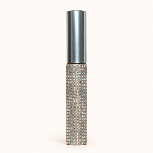 IAMROYLT The Luxe Stayn lip stain in an embellished tube with a silver cap on a warm ivory background.